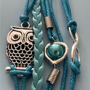 Bracelet with 8 strands of blue string. Silver owl and blue bead.  NWOT
